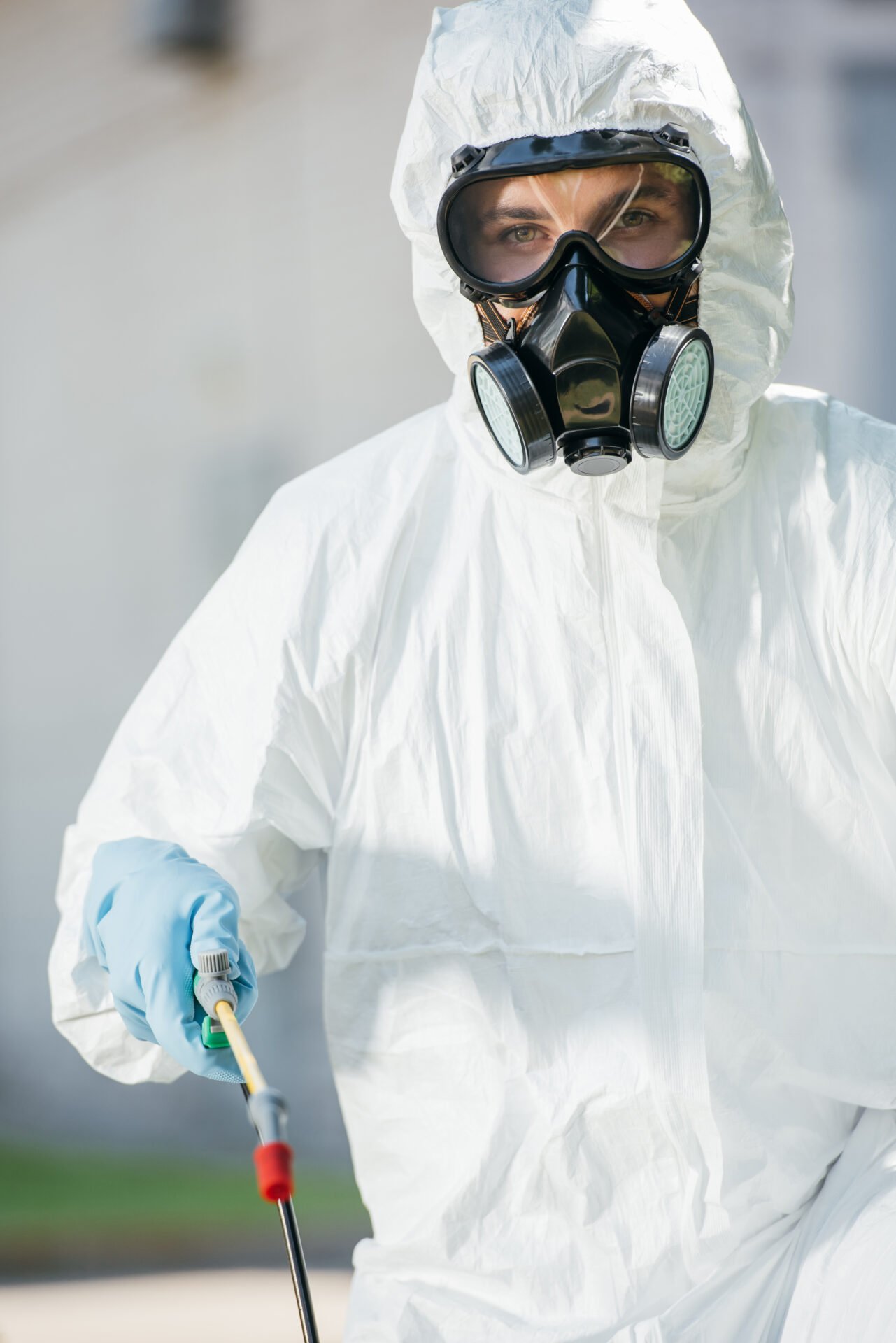 portrait of pest control worker in respirator looking at camera